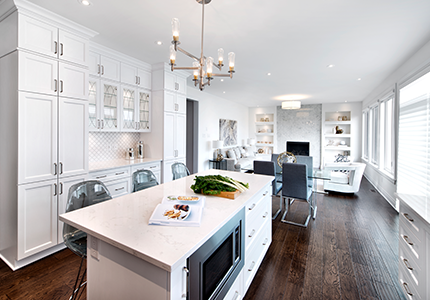 Kitchen island with granite countertops and dining and great room beyond.