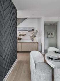 Ficus Dining Room with a dark grey paneled feature wall that separates the Dining Room from the Kitchen.