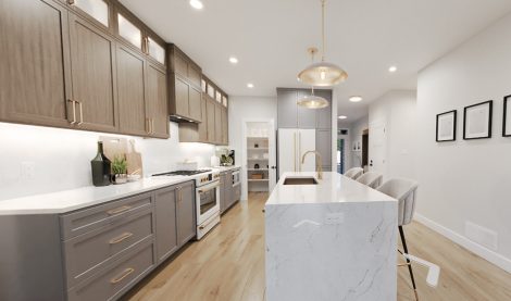 Kitchen with island, cabinets to the ceiling and a walk-in pantry.
