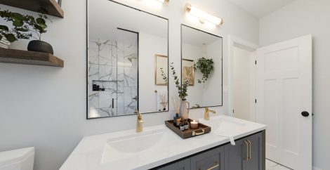 Primary Ensuite with two sinks, two mirrors, shower and gold fixtures.